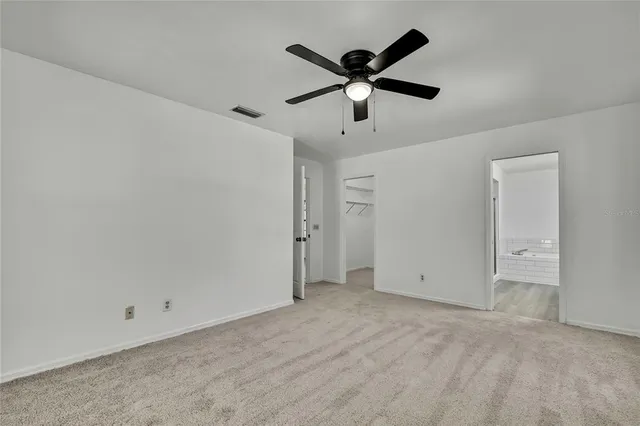 a bathroom with a double vanity sink and mirror with bathtub