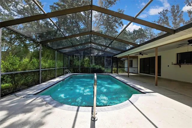an aerial view of residential houses with outdoor space and trees