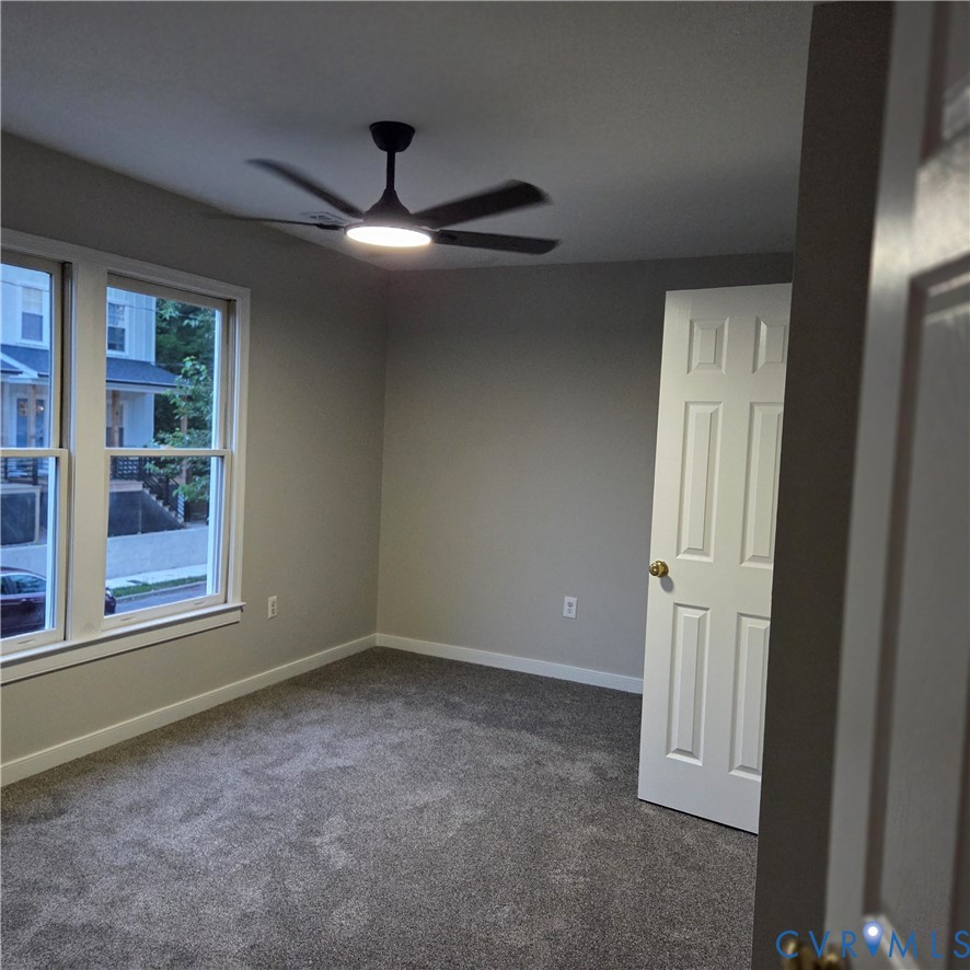 124 Lipscomb Street Richmond, VA 23224 - Photo 6 of 10 Spacious room featuring gray carpet flooring, neut