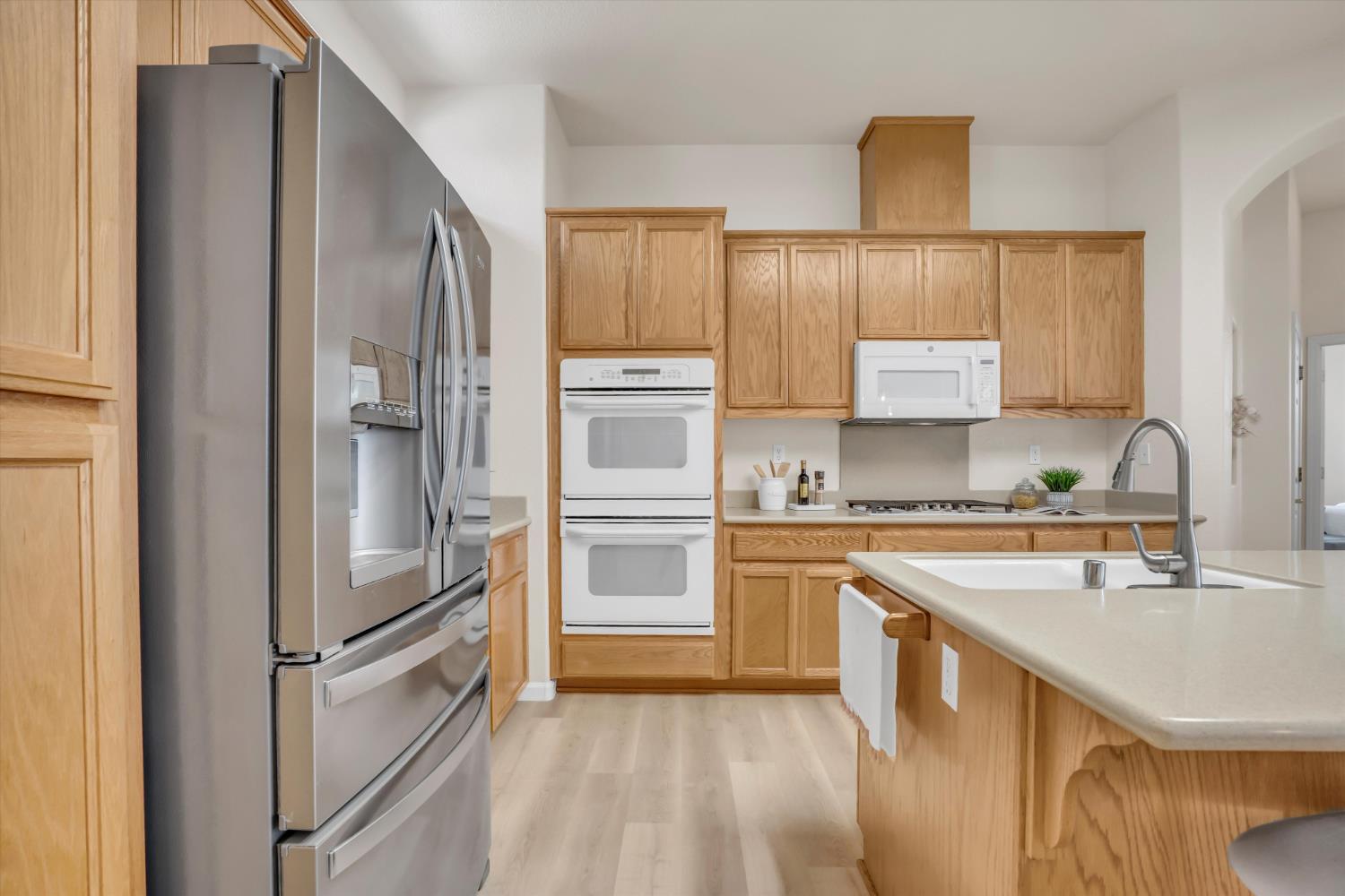 1678 Calhoun Avenue Ripon, CA 95366 - Photo 12 of 31 a kitchen with stainless steel appliances a refrigerator sink and cabinets
