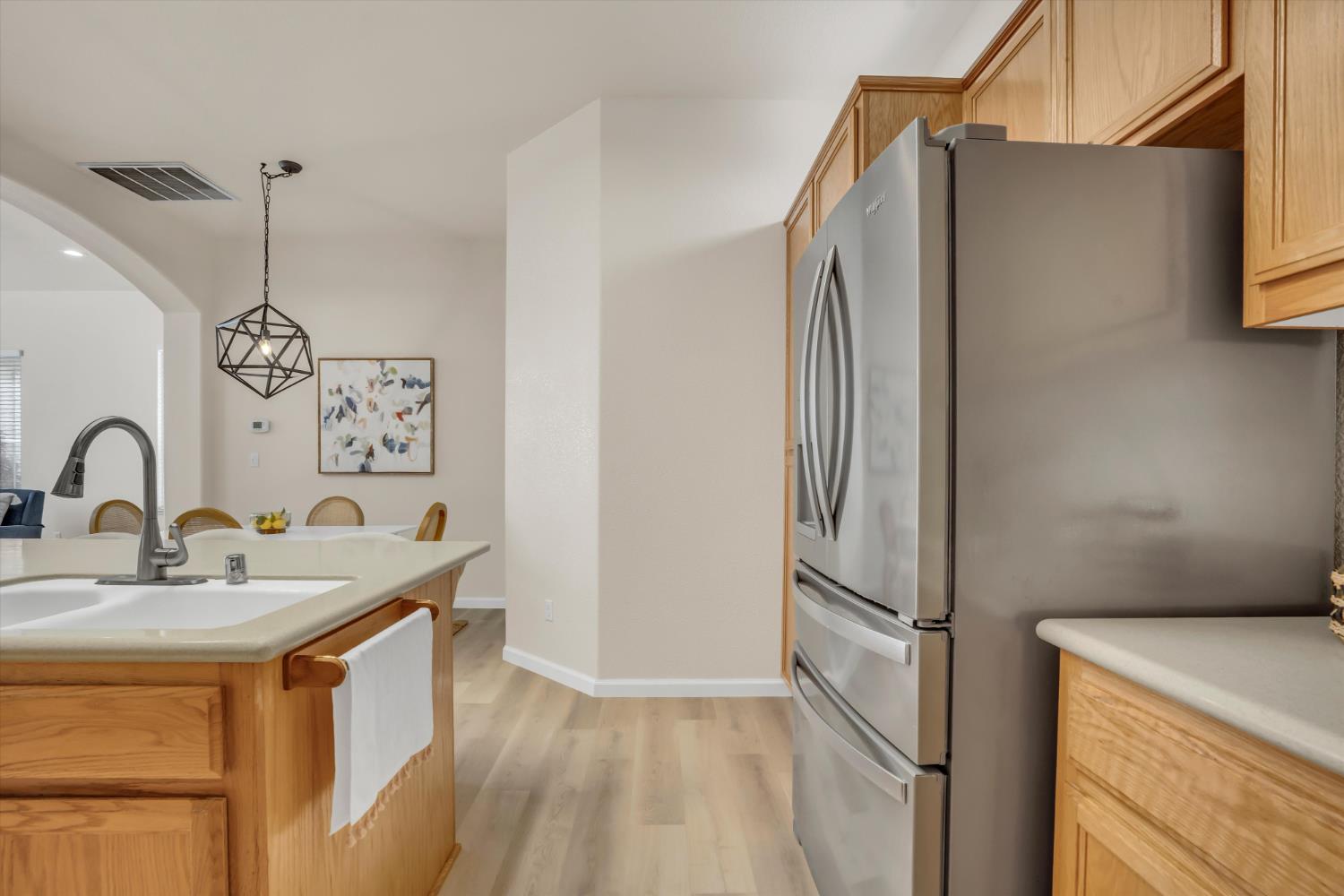 1678 Calhoun Avenue Ripon, CA 95366 - Photo 13 of 31 a kitchen with stainless steel appliances granite countertop a refrigerator and a sink