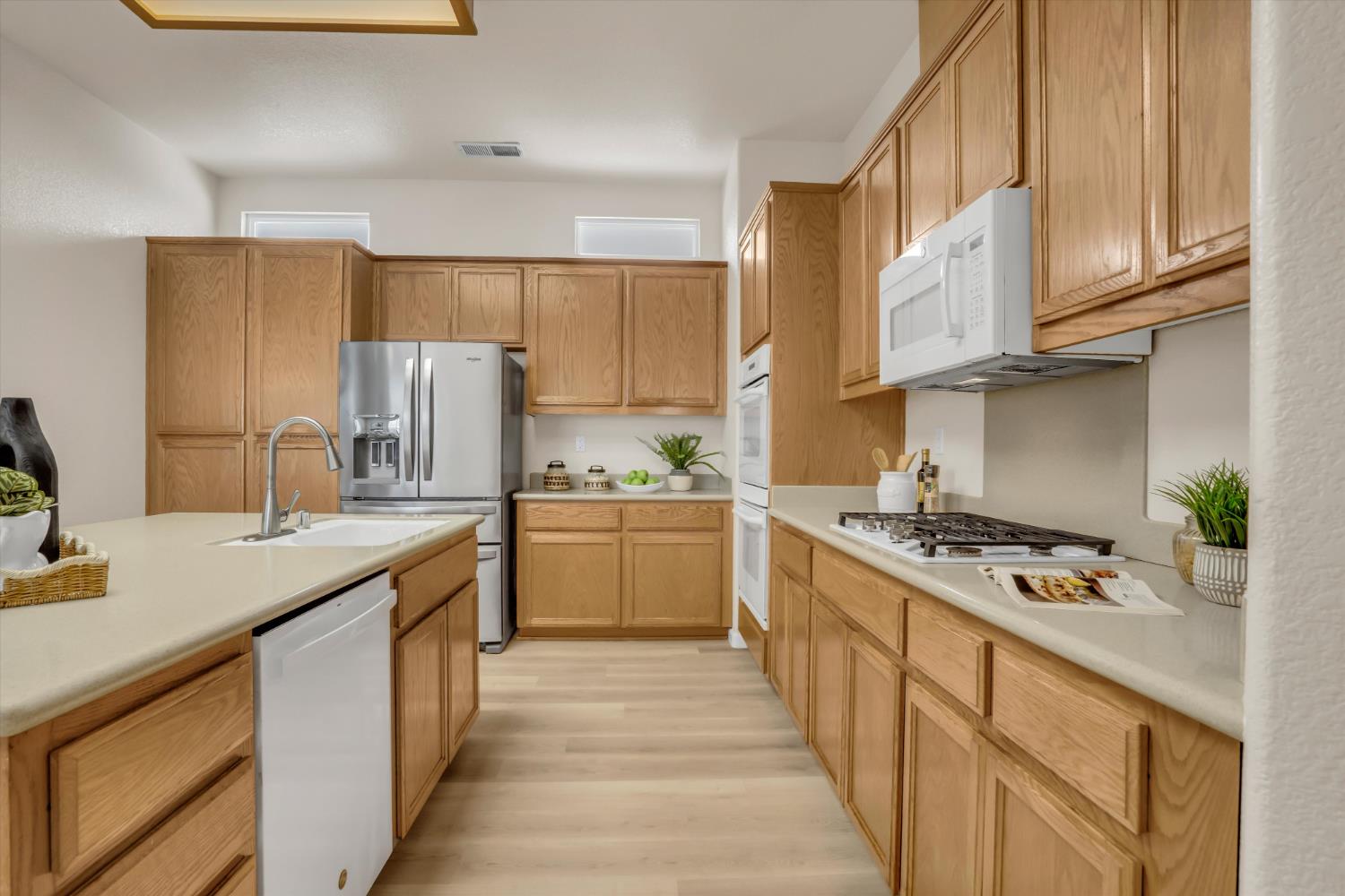 1678 Calhoun Avenue Ripon, CA 95366 - Photo 15 of 31 a kitchen with granite countertop a sink stove refrigerator and cabinets