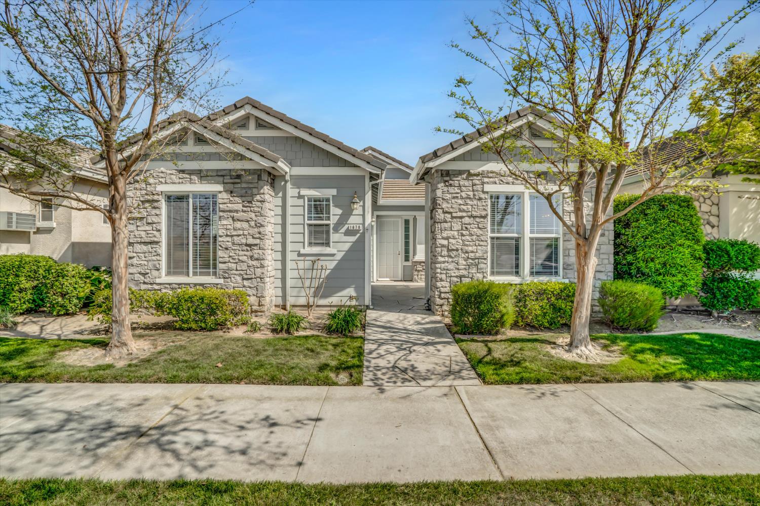 1678 Calhoun Avenue Ripon, CA 95366 - Photo 2 of 31 a front view of a house with a yard and potted plants
