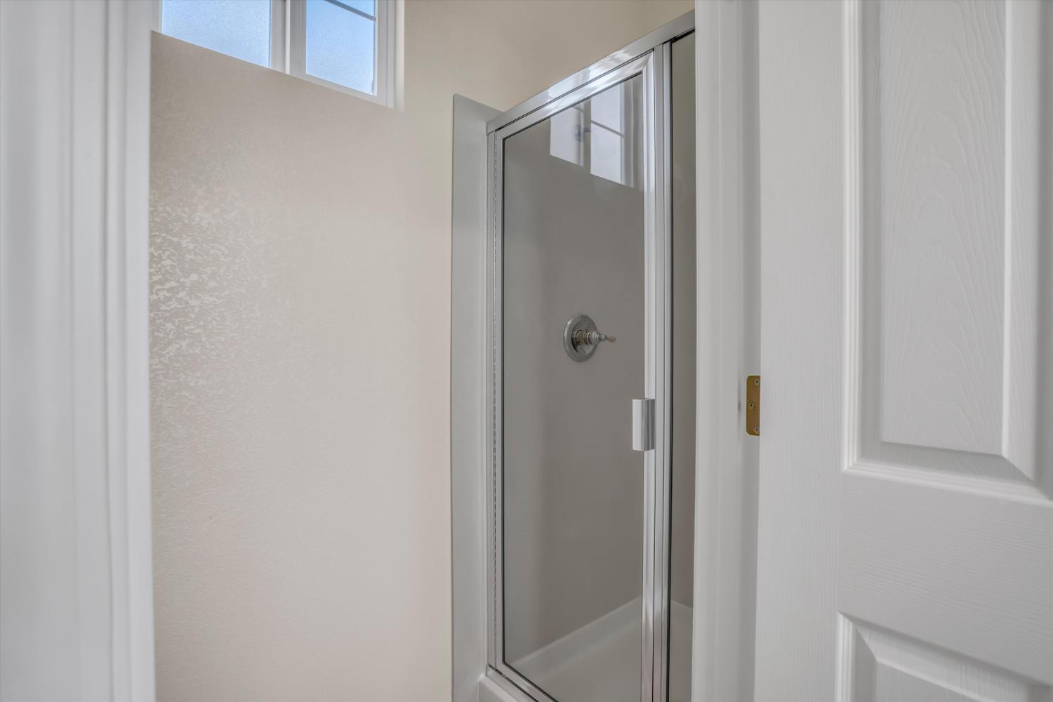 1678 Calhoun Avenue Ripon, CA 95366 - Photo 27 of 31 a bathroom with a glass shower door