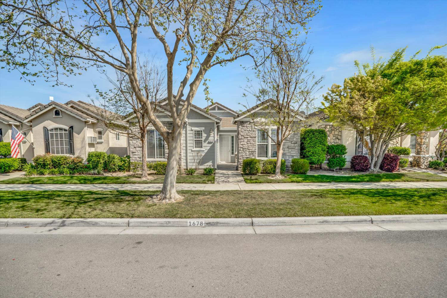 1678 Calhoun Avenue Ripon, CA 95366 - Photo 5 of 31 a front view of a house with a yard