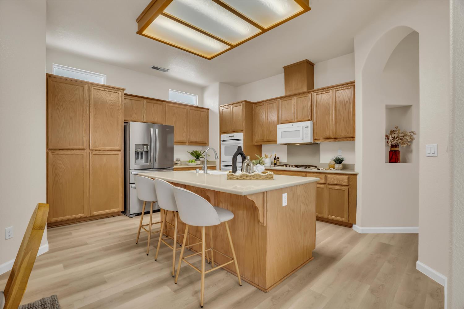 1678 Calhoun Avenue Ripon, CA 95366 - Photo 10 of 31 a kitchen with stainless steel appliances granite countertop a refrigerator a sink dishwasher a stove with white cabinets and wooden floor