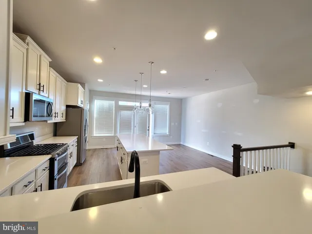 a view of a room with wooden floors and stairs