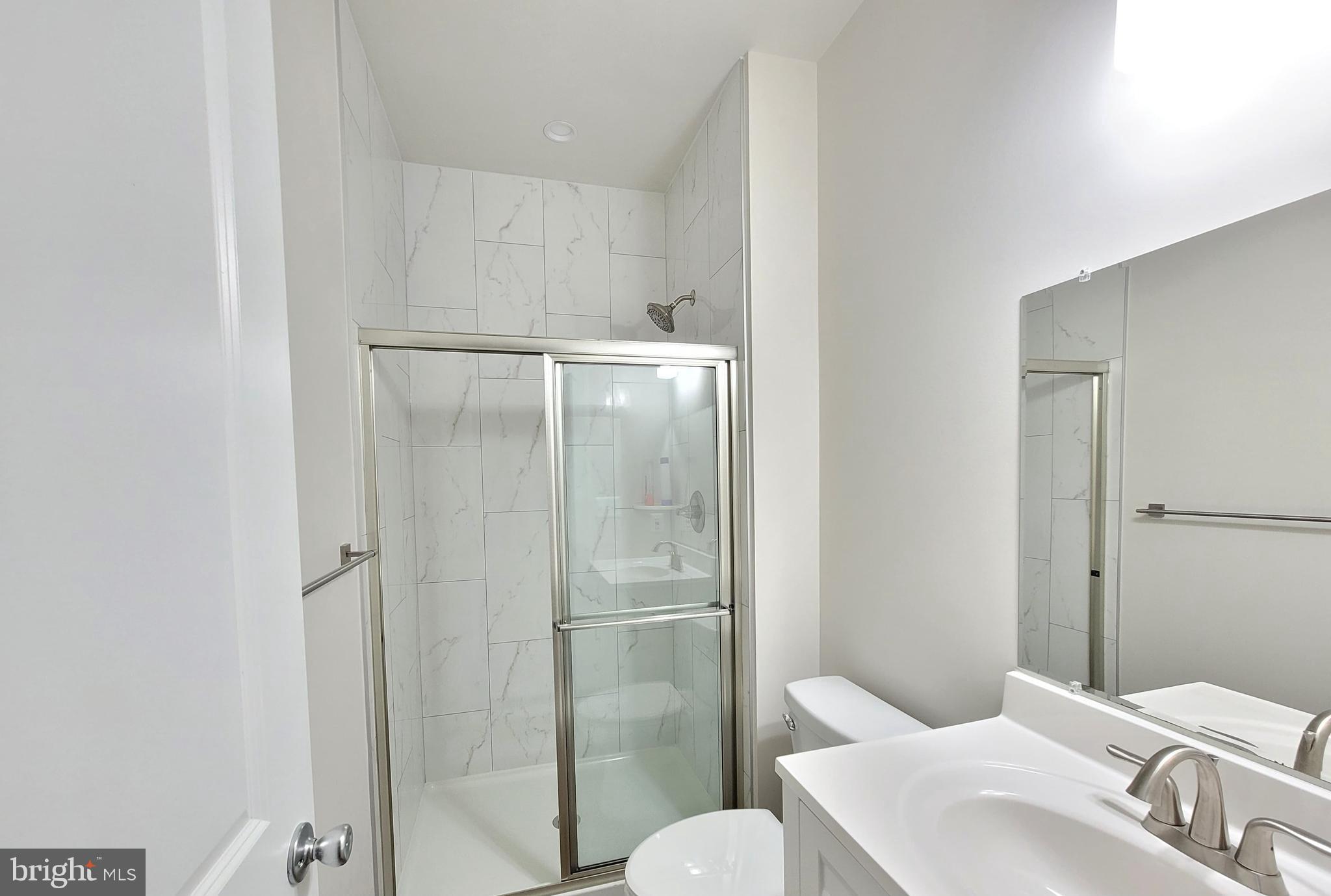 8571 Red Sage Way South Frederick, MD 21704 - Photo 13 of 17 a bathroom with a toilet a sink and shower