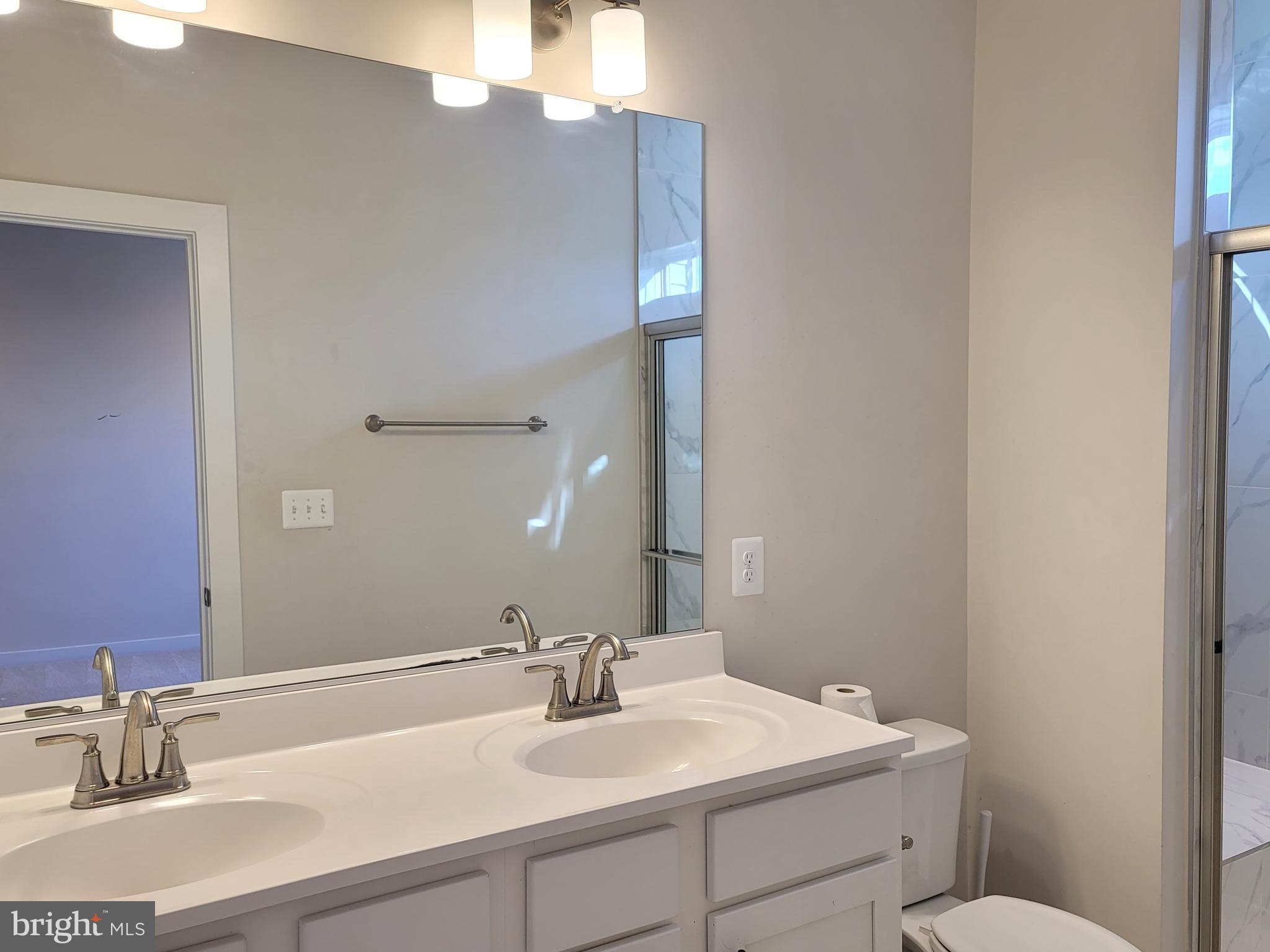 8571 Red Sage Way South Frederick, MD 21704 - Photo 15 of 17 a bathroom with a sink vanity and a toilet