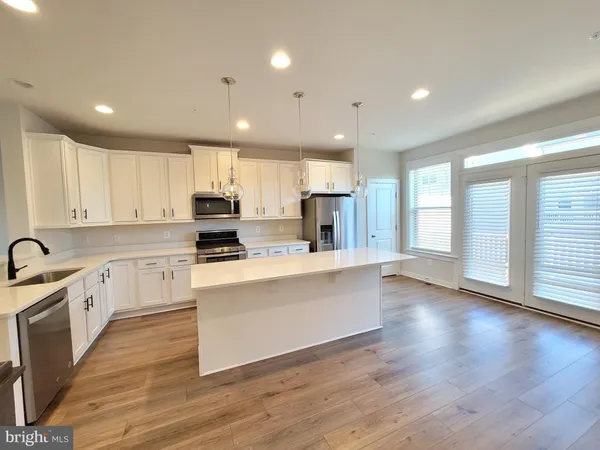 a view of an entryway with wooden floor