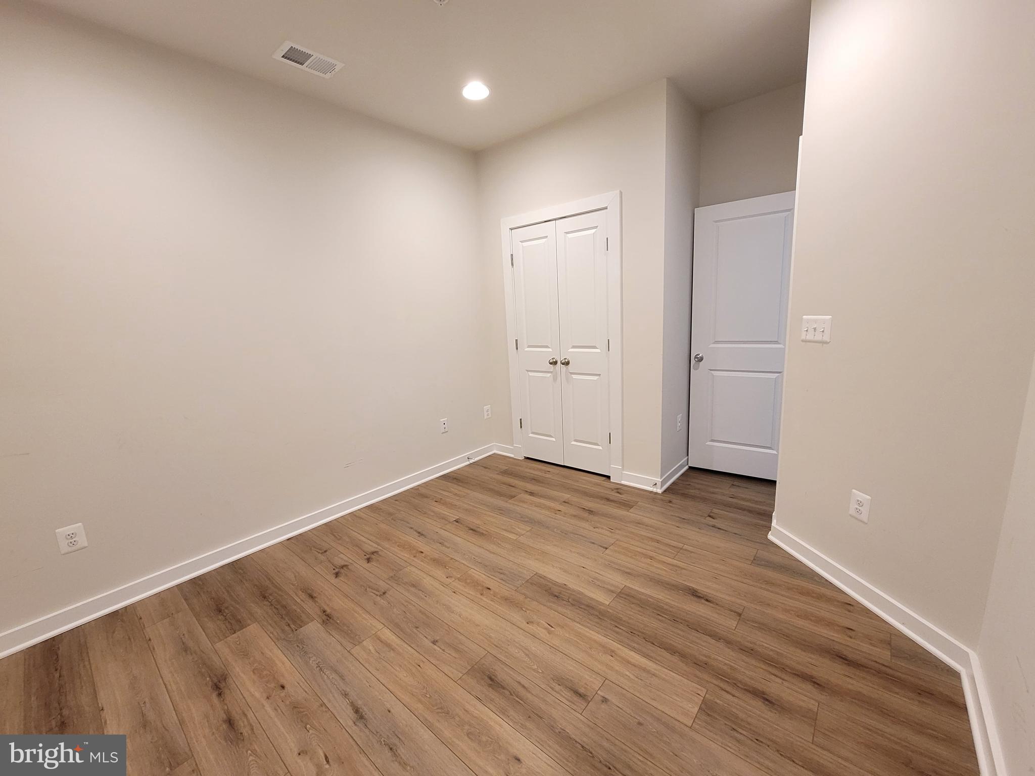 8571 Red Sage Way South Frederick, MD 21704 - Photo 8 of 17 a view of an empty room with wooden floor