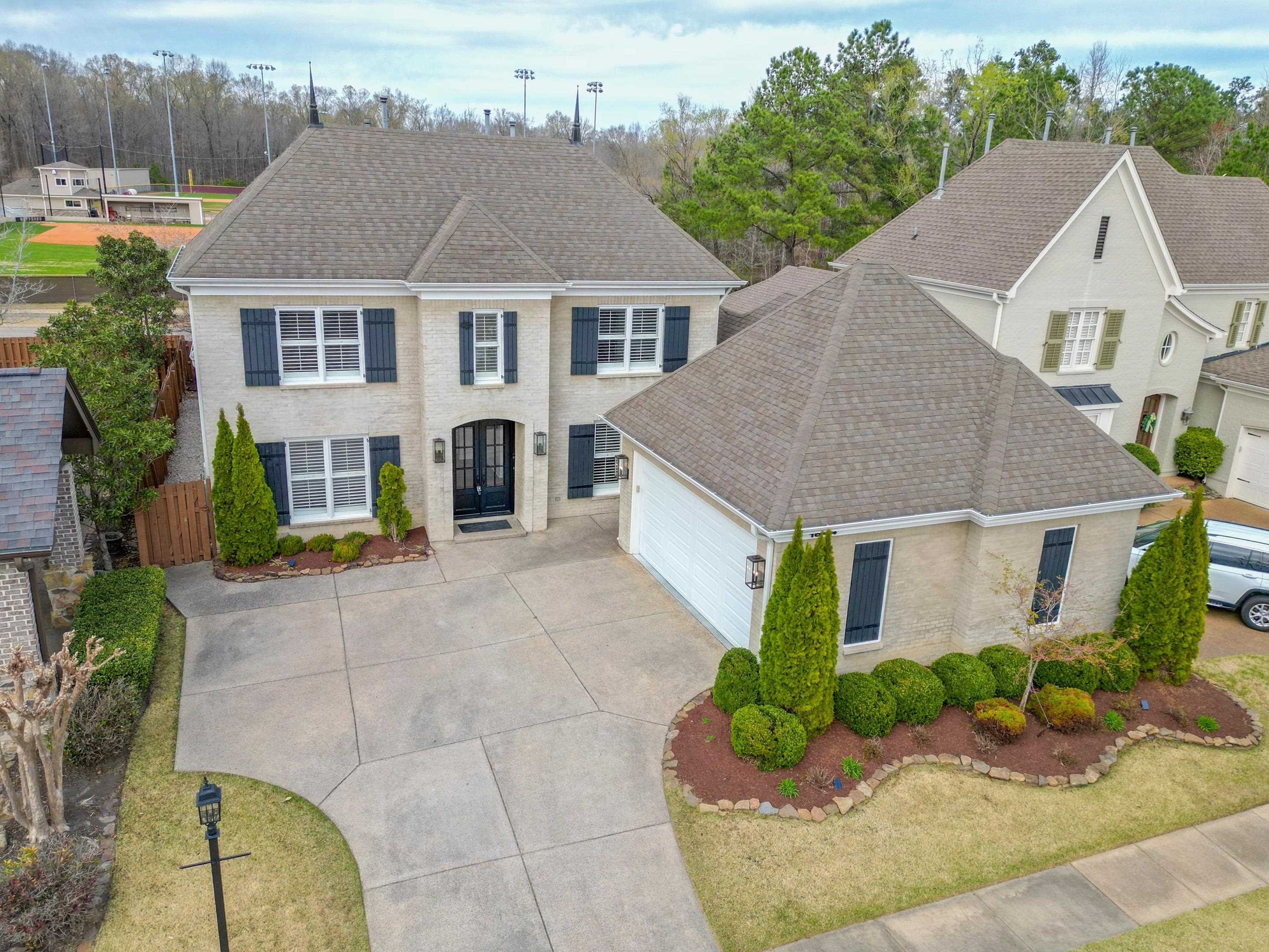 1844 Penshurst Drive Collierville, TN 38017 - Photo 2 of 40 View of front of home featuring driveway, an attached garage, and a shingled roof