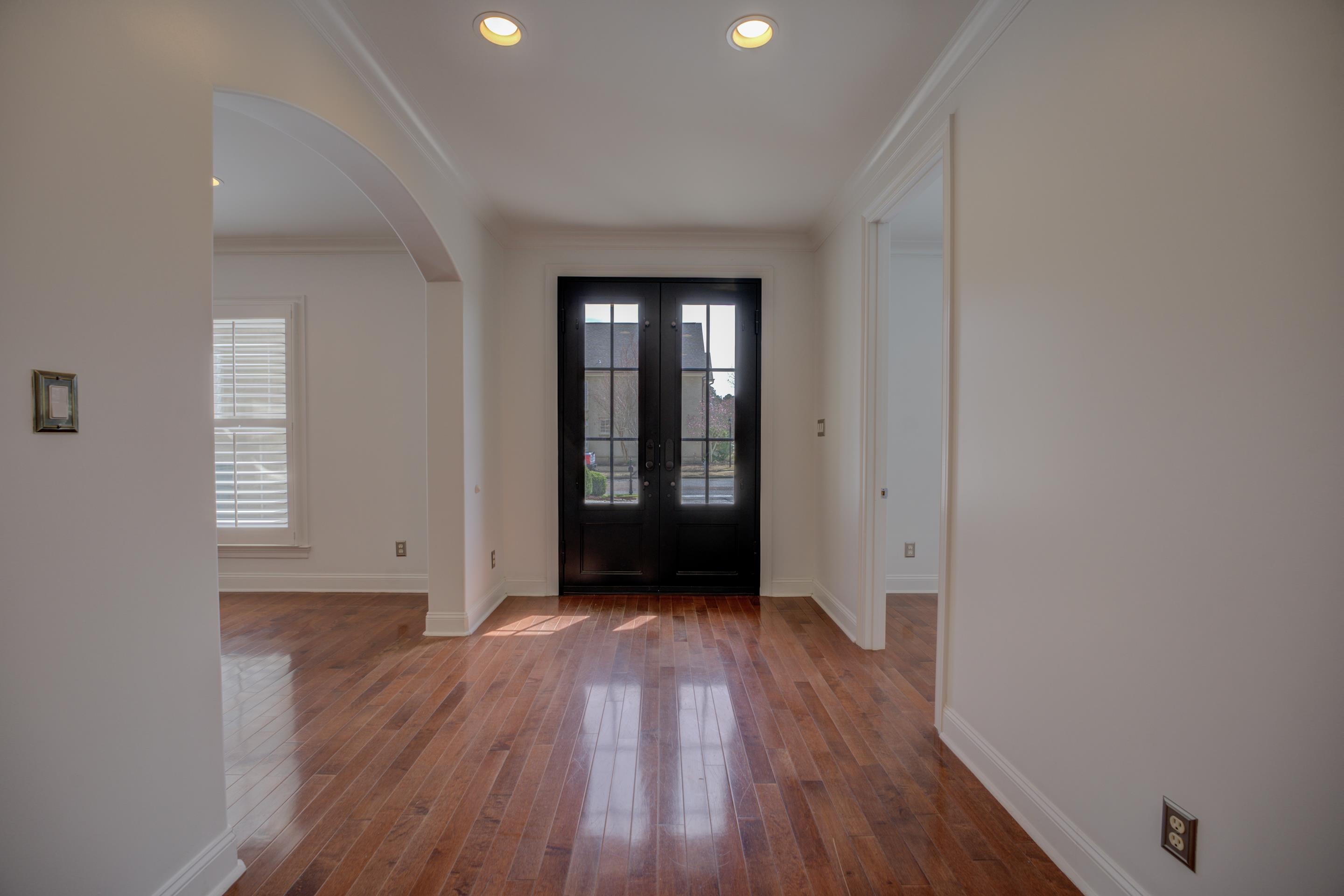 1844 Penshurst Drive Collierville, TN 38017 - Photo 5 of 40 Entrance foyer featuring crown molding, baseboards, french doors, hardwood / wood-style flooring, and arched walkways
