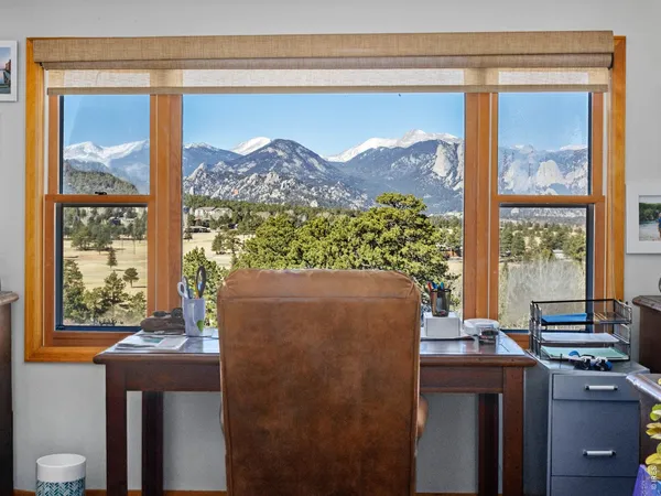 a living room with furniture a flat screen tv next to a large window