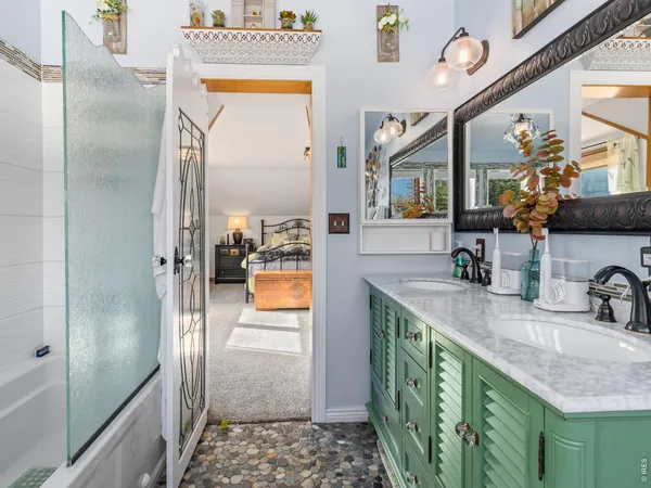a bathroom with a granite countertop sink mirror vanity and toilet