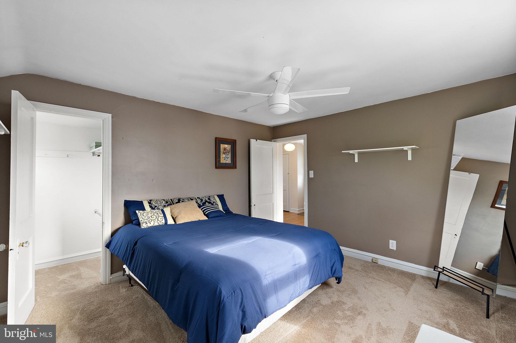 305 Troy Avenue Wilmington, DE 19804 - Photo 16 of 26 a spacious bedroom with a bed and a chandelier