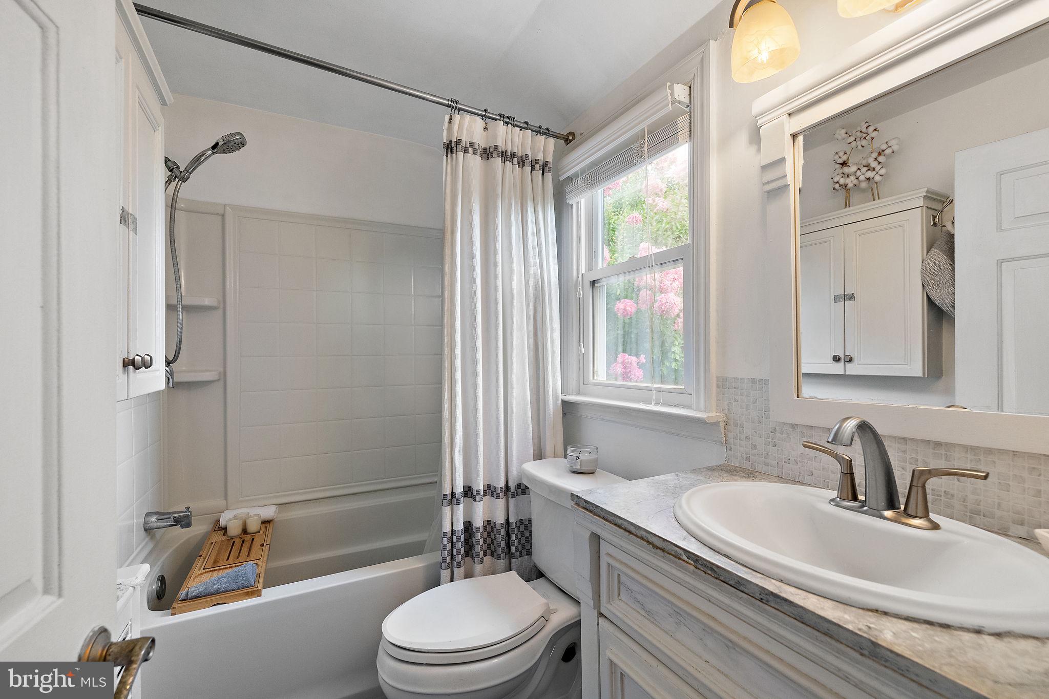 305 Troy Avenue Wilmington, DE 19804 - Photo 17 of 26 a bathroom with a granite countertop sink toilet a mirror and shower
