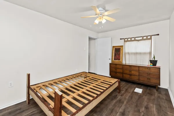 a bedroom with a bed and a dresser