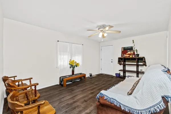 a living room with furniture and wooden floor