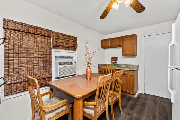 a view of a dining room with furniture and wooden floor