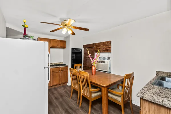 a dining room with furniture and wooden floor