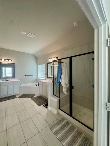 a bathroom with a shower and a bathtub