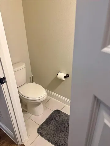 a white toilet sitting next to a sink