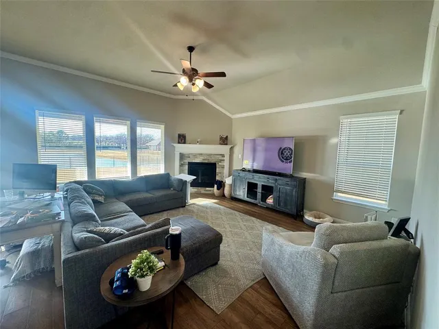 a living room with furniture and a flat screen tv