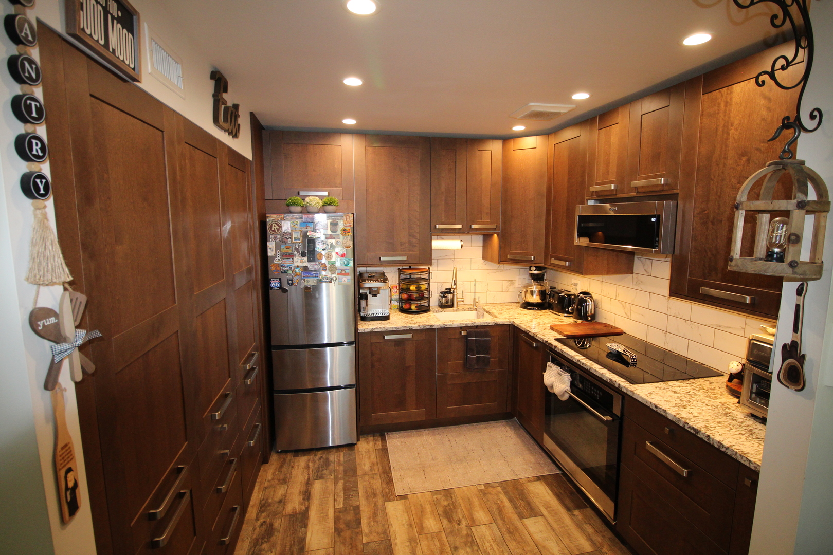 1700 Robin Lane, Unit 1D Hoffman Estates, IL 60169 - Photo 7 of 18 a kitchen with stainless steel appliances granite countertop a refrigerator and a sink