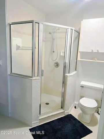 a bedroom with a bed and painting on the wall