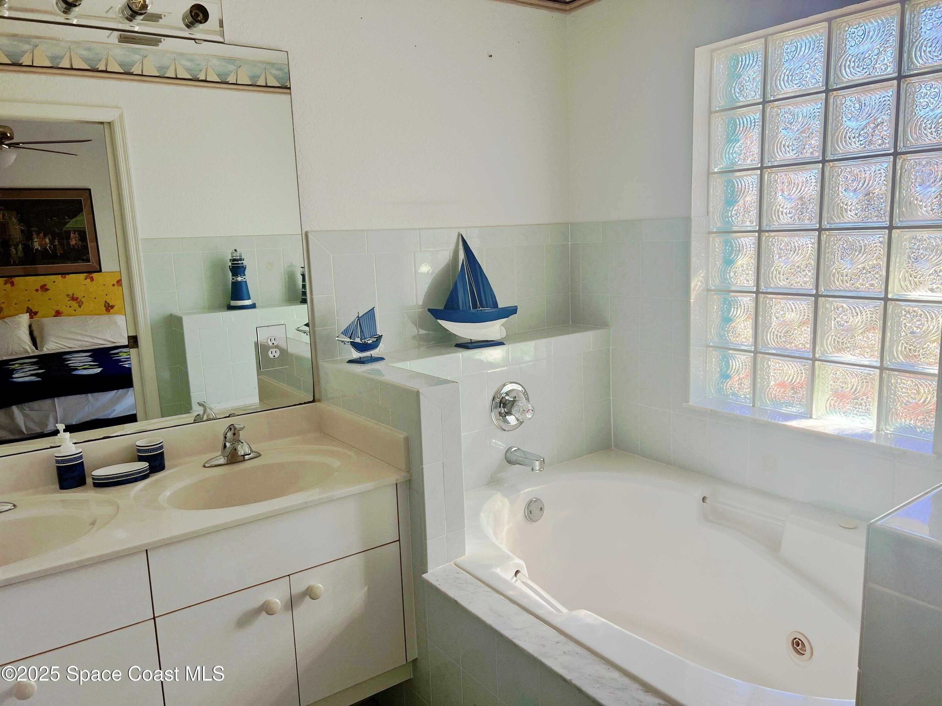 150 Sandy Shoes Drive Melbourne Beach, FL 32951 - Photo 20 of 31 a bathroom with a sink and a window