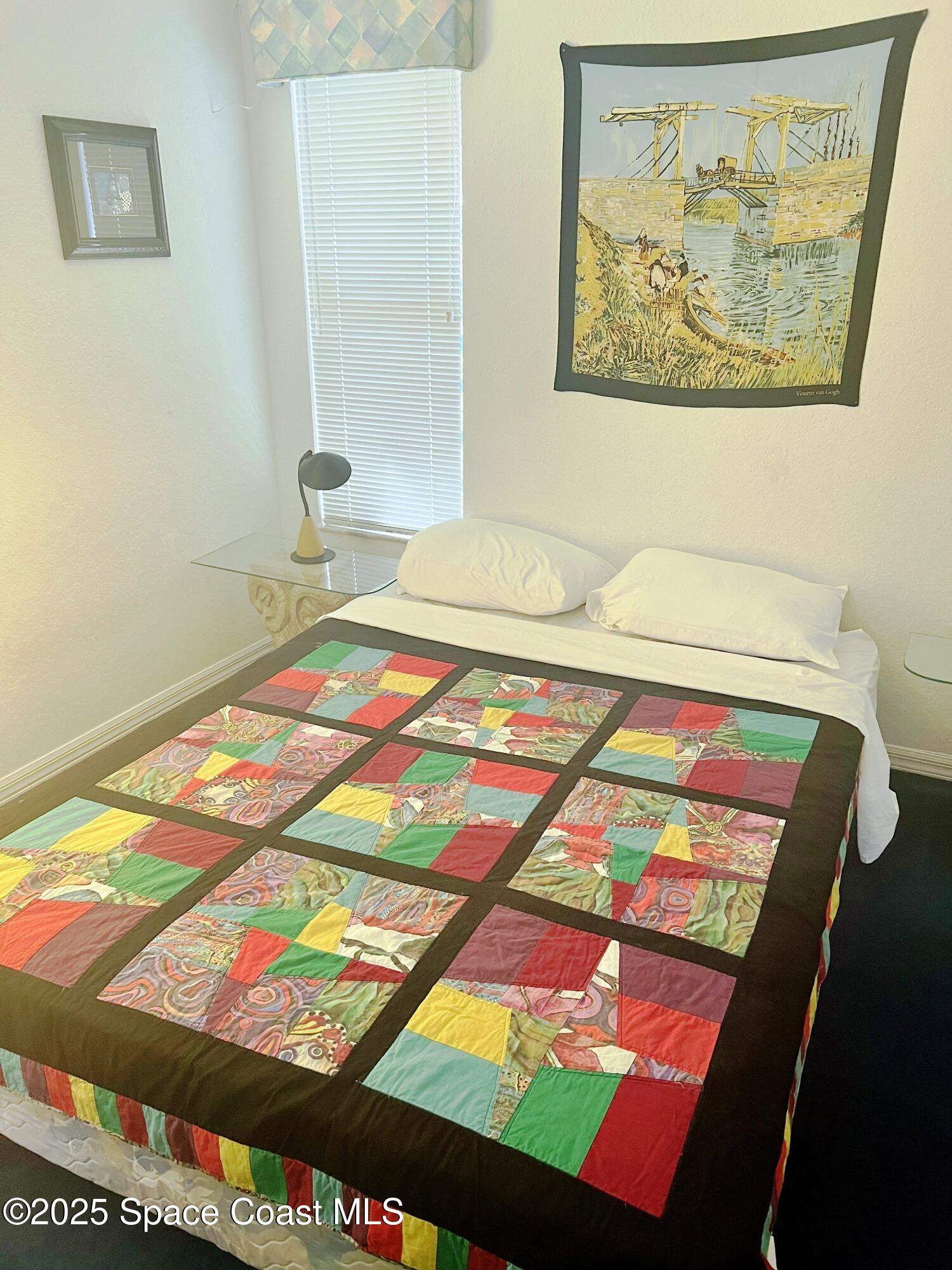 150 Sandy Shoes Drive Melbourne Beach, FL 32951 - Photo 22 of 31 a bedroom with a bed and painting on the wall