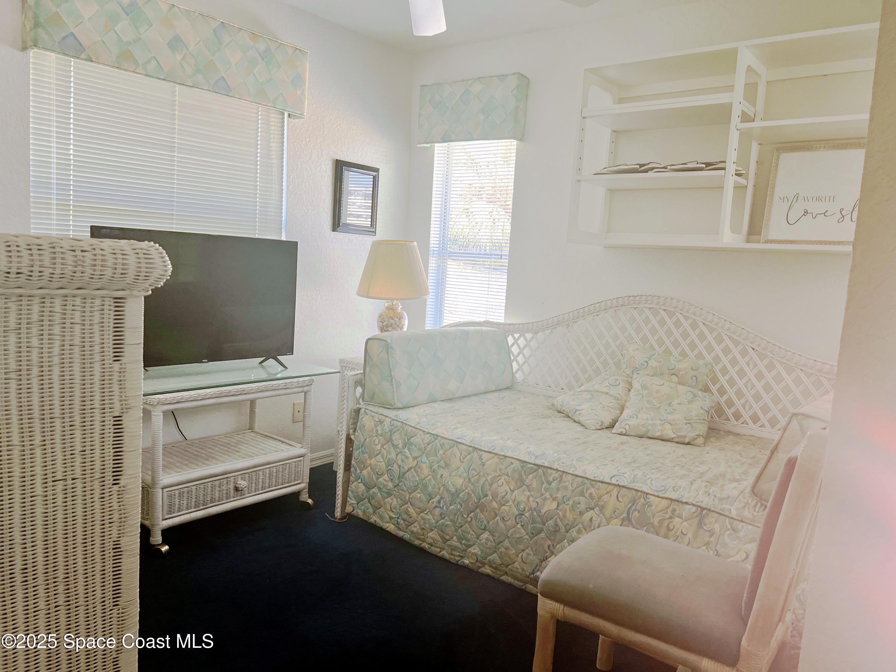 150 Sandy Shoes Drive Melbourne Beach, FL 32951 - Photo 23 of 31 a living room with furniture and a flat screen tv