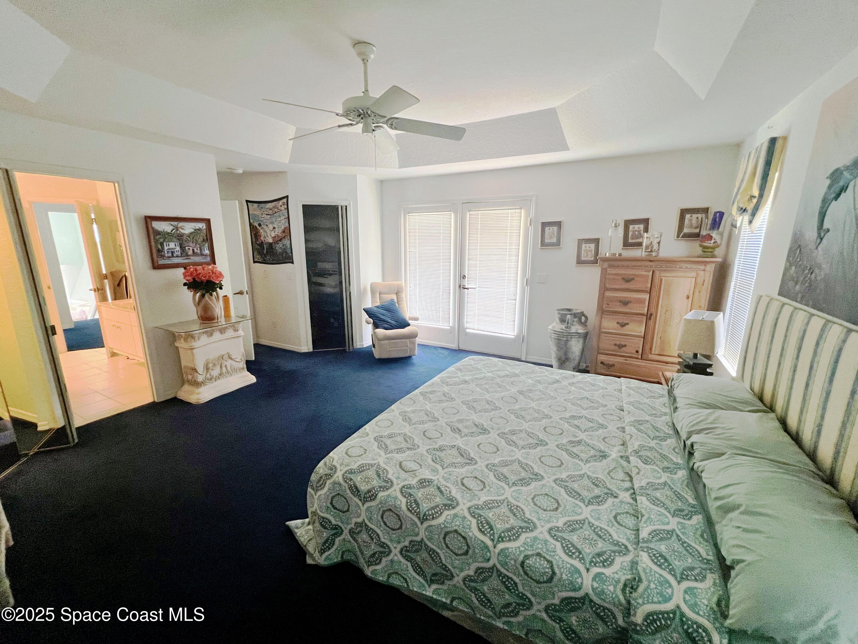 150 Sandy Shoes Drive Melbourne Beach, FL 32951 - Photo 25 of 31 a bedroom with a bed and wooden floor