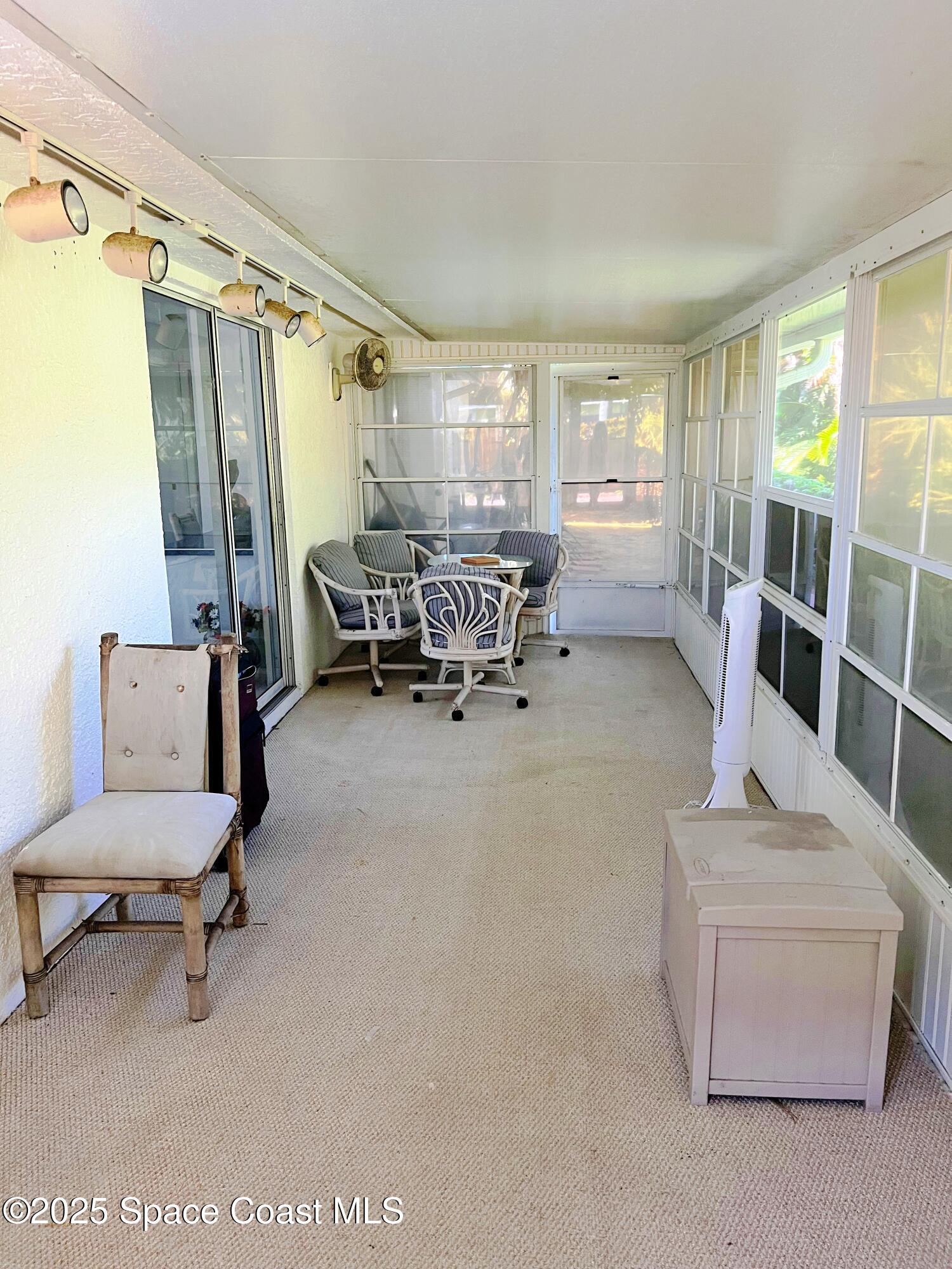 150 Sandy Shoes Drive Melbourne Beach, FL 32951 - Photo 27 of 31 a living room with furniture and a large window