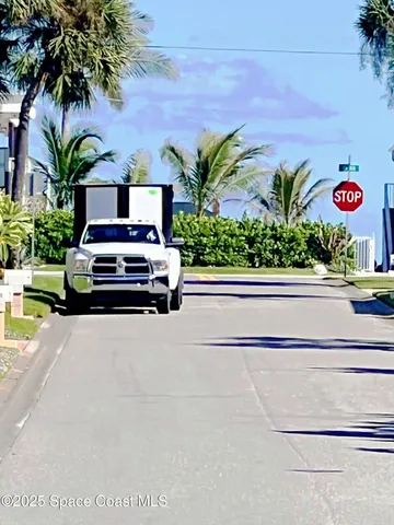 a car parked in front of a house with potted plants