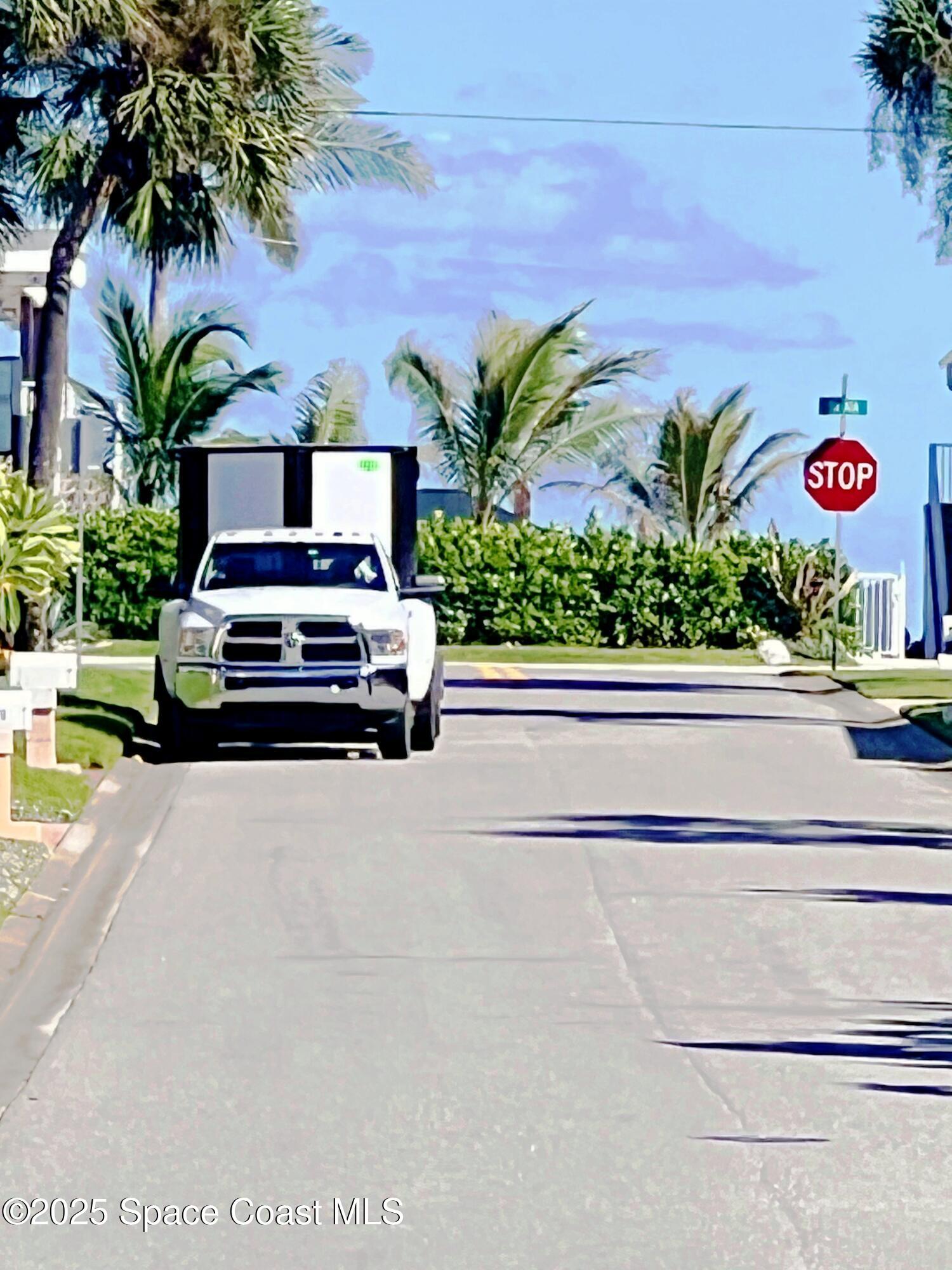 150 Sandy Shoes Drive Melbourne Beach, FL 32951 - Photo 3 of 31 a car parked in front of a house with potted plants