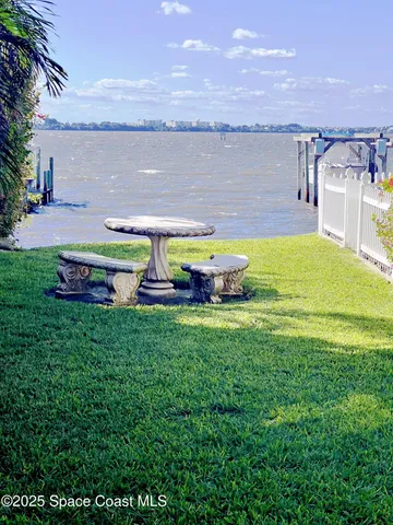 a swimming pool with outdoor seating and yard