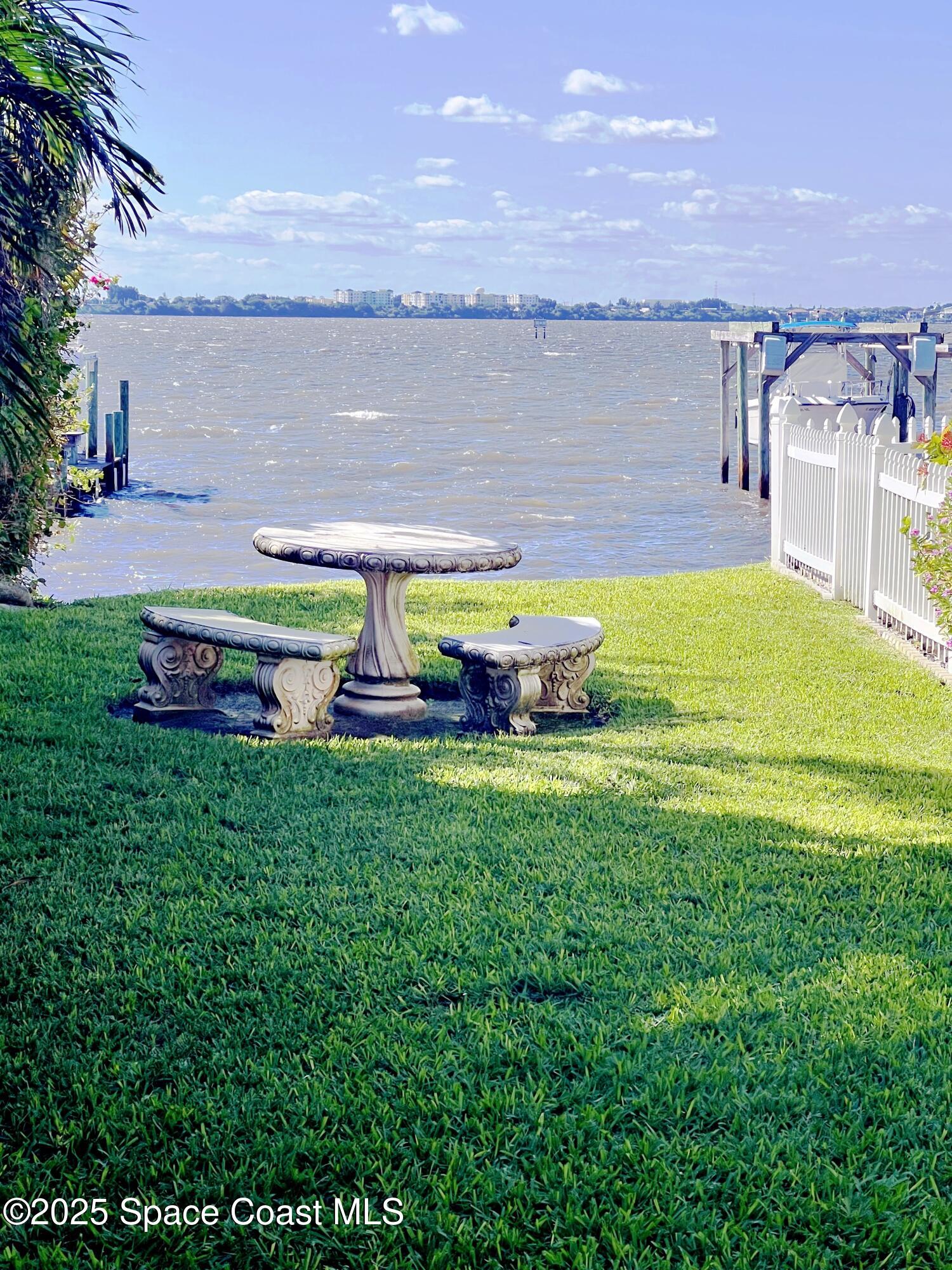 150 Sandy Shoes Drive Melbourne Beach, FL 32951 - Photo 4 of 31 a swimming pool with outdoor seating and yard