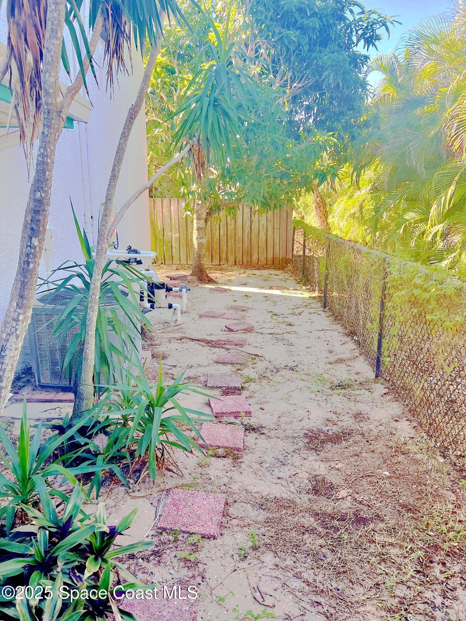 150 Sandy Shoes Drive Melbourne Beach, FL 32951 - Photo 7 of 31 a view of a yard with plants and tree