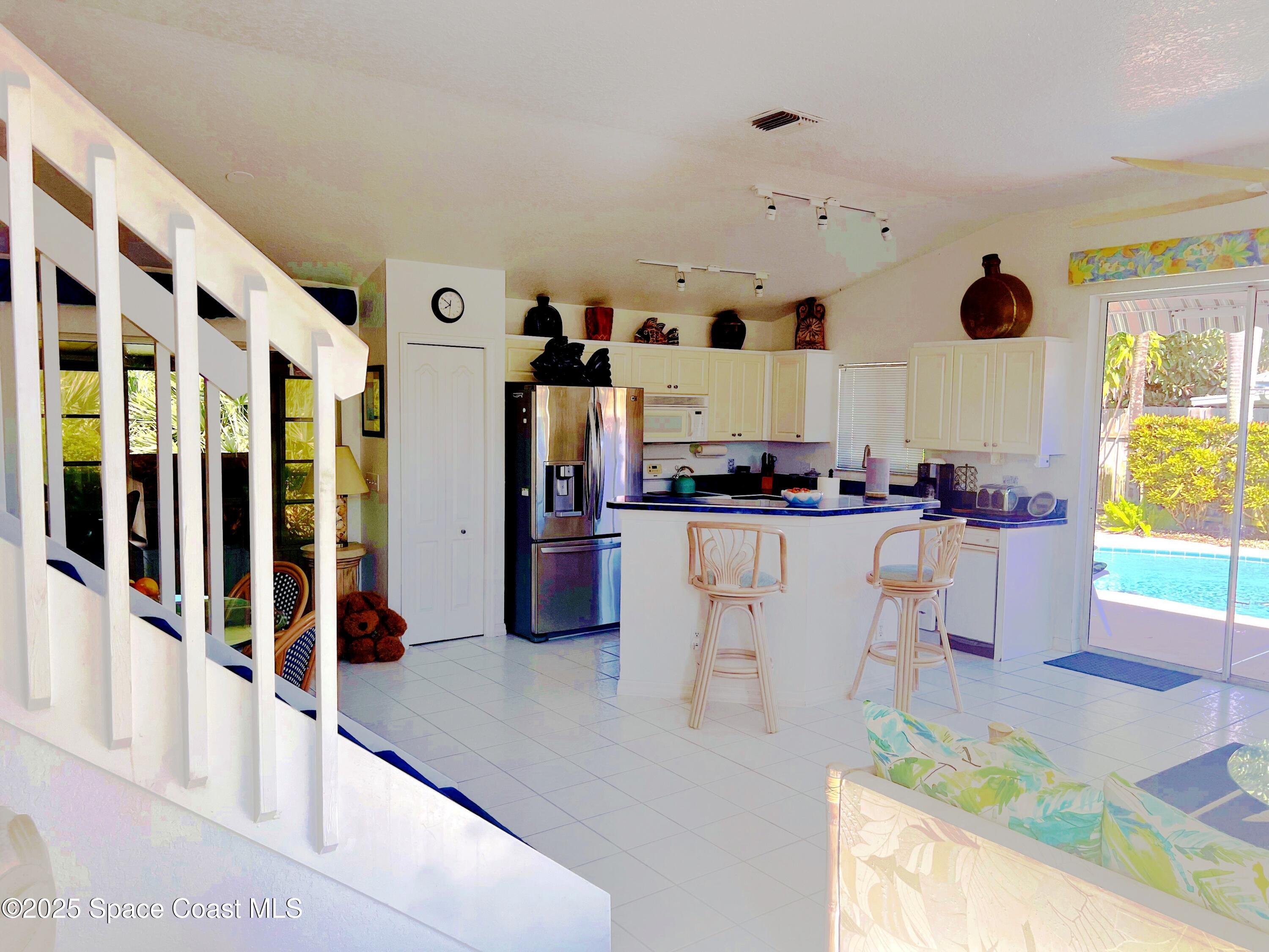 150 Sandy Shoes Drive Melbourne Beach, FL 32951 - Photo 10 of 31 a kitchen with stainless steel appliances granite countertop a sink and a refrigerator