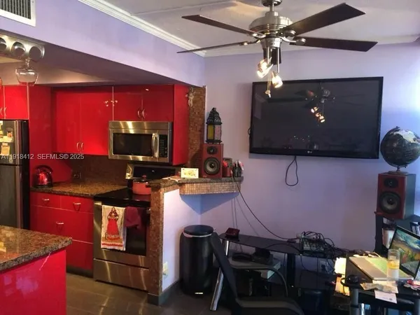 a view of a dining room with furniture and chandelier