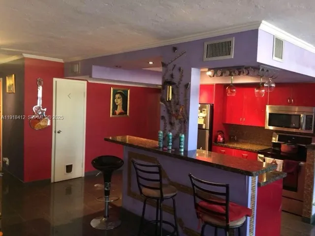 a bathroom with a granite countertop sink a large mirror and a shower