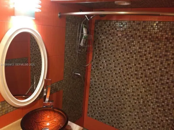 a bathroom with a toilet mirror and vanity