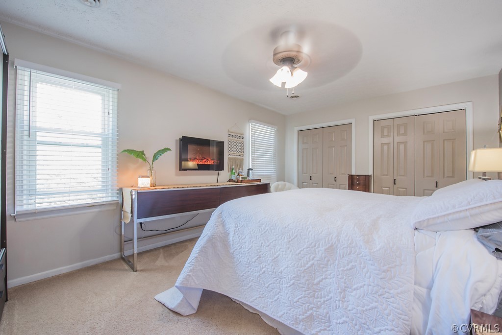 1532 Austin Road Chester, VA 23836 - Photo 30 of 50 a spacious bedroom with a bed and a chandelier