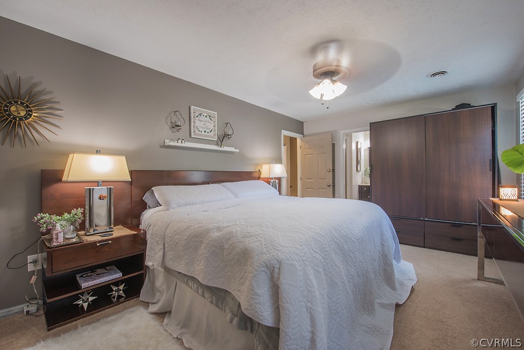 1532 Austin Road Chester, VA 23836 - Photo 31 of 50 a spacious bedroom with a bed and a lamp