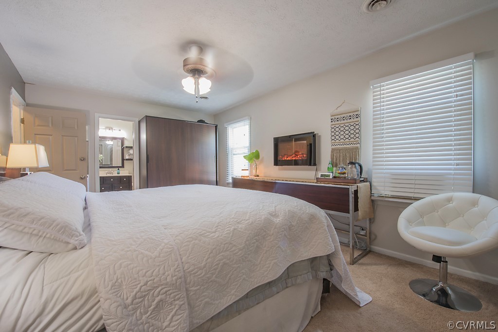 1532 Austin Road Chester, VA 23836 - Photo 32 of 50 a spacious bedroom with a bed a chandelier and mirror