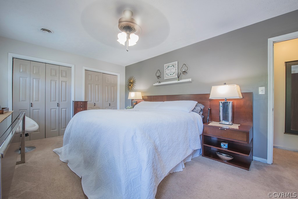 1532 Austin Road Chester, VA 23836 - Photo 33 of 50 a spacious bedroom with a bed and a chandelier