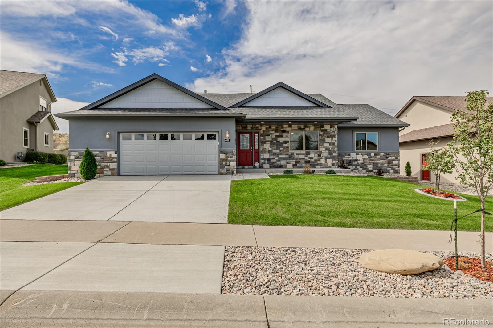 a front view of a house with a yard and garage