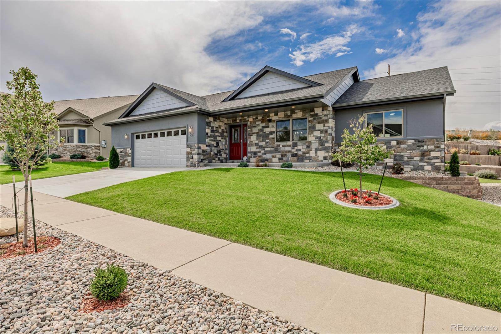 407 Double Tree Drive Greeley, CO 80634 - Photo 2 of 50 a front view of a house with a yard table and chairs